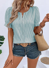 Front view of teal Wavelle Blouse showcasing wavy texture and U-neck slit.