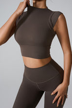 a model posing in the mocha mock neck active tank top
