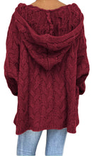 A model showcasing the back of a wine color Skyloft Cable-Knit Hooded Sweater paired with jewelry, and blue denim jeans.