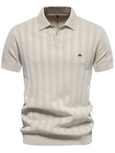 Front view of beige Onyx Luxe Knit Polo showing collared neck, embroidered detail, and two-button placket.
