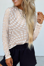 Model wearing beige ChicGrid checkered mock neck blouse paired with jean shorts and layered jewelry, styled for a chic casual look.