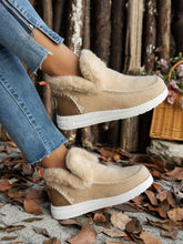 Model wearing the beige Furry Suede Round Toe Flat Sneakers, side angle