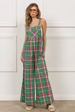 Model in BiBi Plaid Overalls layered with a cozy cardigan and ankle boots for fall style.