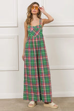 Model styling BiBi Check Plaid Overalls with a lightweight denim jacket and white sneakers.