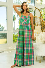 Model standing in jade pink BiBi Multi-Color Check Plaid Overalls front view with rolled cuffs and sneakers.