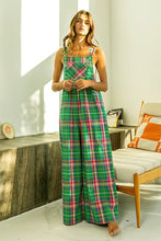 Model front view in BiBi Check Plaid Overalls paired with bare feet at a beach cottage.
