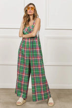 Model in BiBi Plaid Overalls styled with gold hoop earrings, tan open-toe heels, and a halter crop top.