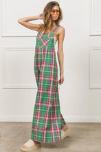Side profile of model wearing BiBi Jade/Pink Plaid Overalls highlighting wide-leg cut.