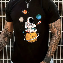 Close-up front view of astronaut and planet graphic on black Cosmic Voyager tee