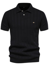 Front view of black Onyx Luxe Knit Polo with embroidered detail and short sleeve design.