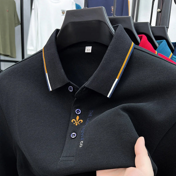 Close-up front view of black Royale Crest Fleur de Lis Polo showing embroidered placket detail.