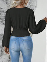 Back view illustrating the black Balloonique blouse's fit and design.