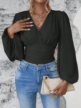 Model styled in black Balloonique™ Blouse with accessories for a complete look.