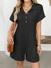 Woman in black Button Detail Collared Neck Short Sleeve Romper seated on a bench.
