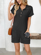 Black romper worn casually with sneakers, model seated on bench.