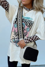 Model wearing the black ChicGrid checkered mock neck blouse paired with distressed leggings, layered tee, long wide straped purse, and
jewelry, styled for a chic casual look.
