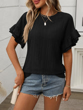 Model wearing Contrast Round Neck Short Sleeve Blouse in black, paired with denim jeans, standing against a neutral backdrop.