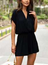 Model in black romper paired with block heels and a leather crossbody, walking urban streets—effortlessly chic for city days or night-out confidence.