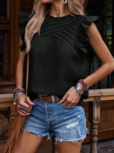 Model wearing a frill mock neck ruffled cap sleeve blouse in black, styled with light blue distressed jean shorts, brown crossbody bag, jewelry, and heels for an elegant yet casual day look.