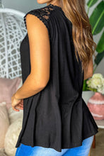 Model styling the black lace trim tank with wide-leg pants and heels for an evening vibe.