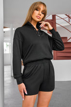 Model wearing a black Half-Button Sweatshirt and Shorts Active Set.