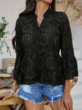 Side view of Luméa™ Blouse in Black, styled with a tan ruffled handbag and sneakers for a casual outing.
