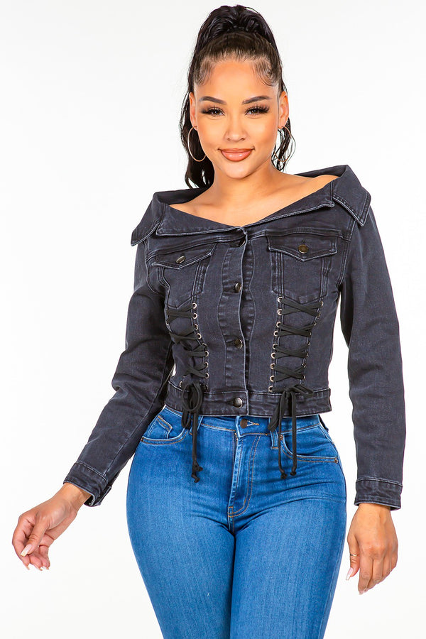 a model wearing the black American Bazi Off Shoulder Lace Up Denim Jacket paired with jewelry and blue jeans