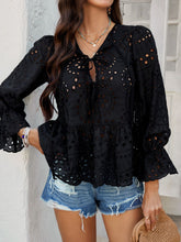 Laid-back lunch date look with model in PeplumMuse™ Blouse in Black, distressed jean shorts, brown straw tote bag, pearl hoop earrings, and tan slip-on sandals.