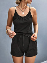Model wearing black Sunkiss Move Romper at an evening rooftop lounge, styled with heels and a leather clutch—minimalist yet elevated for night-out chic.