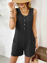 Model seated on neutral-toned bench in black romper, legs crossed, radiating effortless confidence and comfort.