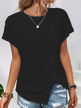 A woman shopping in New York City wearing the black Ruched Wavy Pattern Round Neck Short Sleeve T-Shirt paired with distressed denim shorts, jewelry, and heels.