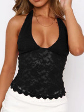 Model wearing black Seraphinelli Lace Halter Blouse with backless silhouette and floral lace.