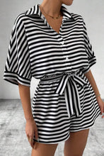 Side profile of LineaVerra™ Black Romper showing button front and tie waist.