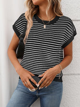 Side profile of model in black striped knit top, styled with white linen pants for an airy summer vibe.