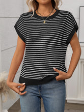 Side profile of model in black striped knit top, styled with white linen pants for an airy summer vibe.