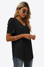 Woman in black V-Neck Puff Sleeve Tee styled with distressed jeans, jewelry, sunglasses, and heels.