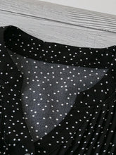Close-up of neckline slit and buttons on black EverDot Flutter Top.