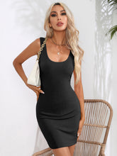 Model in the black Curvalicious Allure Bodycon Mini Dress on an evening city stroll styled with hoop earrings and a chic handbag.