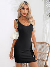 Model front view wearing the black Curvalicious Allure Bodycon Mini Dress styled with gold statement earrings, bangles, and tie strap heels.
