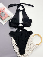 Back flat lay of black cutout halter neck one-piece swimwear highlighting open back and halter strap design
