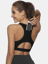 Black cutout scoop neck active tank back view showing pocket.
