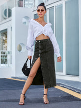 Black Denivéra Button Skirt side pose showing button slit and washed denim texture
