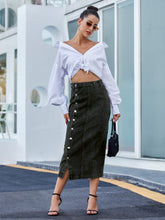 Black Denivéra Button Skirt styled with knotted blouse, sunglasses, hoops, and peep-toe heels