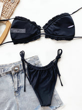Black frill trim halter neck bikini set back flat lay view