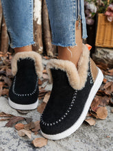 Person wearing the black Furry Suede Round Toe Flat Sneakers