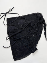 Flat lay front view of black glitter halter neck bikini top, side-tie bottoms, and matching tie-waist cover-up with silver sparkles