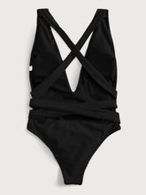 Back flat lay of black halter neck deep V tied one-piece swimsuit showing open back and tie straps