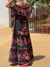 Back view of model in black Isadorae Floral Maxi Dress styled for date night.