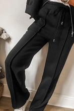 Close up of pants adjustable waist detail in black kalorene zip up top and pants set