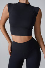 Model posing a front view of the Black color Mock Neck Active Tank.